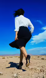 a woman in a skirt runs across the desert