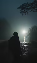a person that is looking at something in the dark