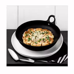 a skillet with some food on it and a spoon