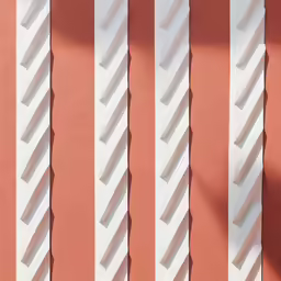 some white and pink striped paint on the side of a building