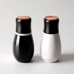 two black and white ceramic salt and pepper mill shakers