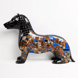 black dog in mosaics on white surface