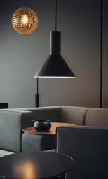 a living room with couch, table and lights