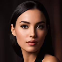 a woman with a dark hair and brown eyes posing for a photo
