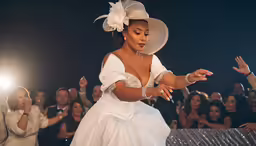 the lady is dressed in white and posing for photos