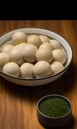 several balls of rice sitting in front of a bowl