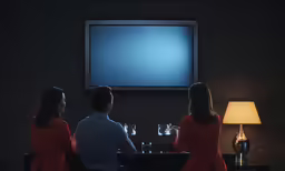 a group of people that are sitting in front of a flat screen tv