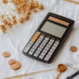 an old calculator with buttons, sewing needles and a yarn - needle