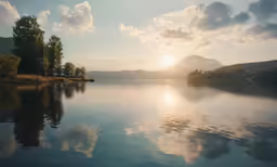 a body of water surrounded by mountains in the background