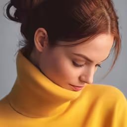 a beautiful woman in yellow sweater holding her nose