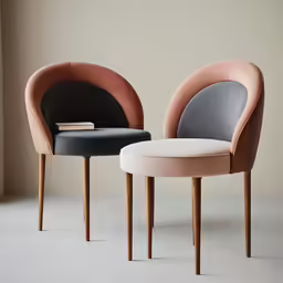 two chairs sitting next to each other in an empty room