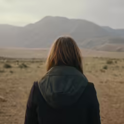 a person standing with their back turned to the camera