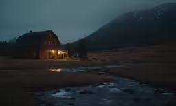 a house lit up with a flashlight near the water