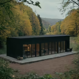 a tiny cabin is set in the woods on stilts