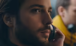 a man on a phone talking to another man