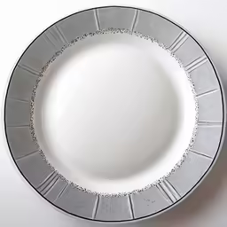 a plate with grey and silver decorations on the rim