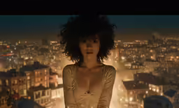 a woman posing at the top of a high rise