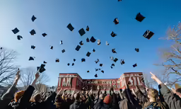 graduation caps and gowns are being thrown into the air