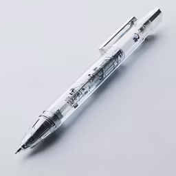 a silver pen on a white surface