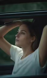 a woman leaning out the window of a car