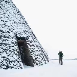 a man standing in front of an interesting structure