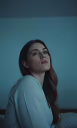 the girl is looking up with her eyes wide open