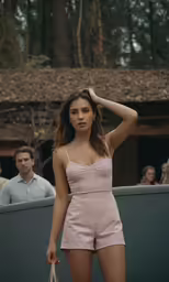 a woman in short shorts is holding her head