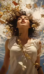 the woman is standing under some yellow leaves