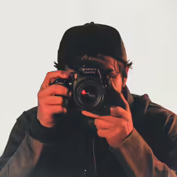 a man holding a camera up to his face