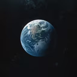 the earth from space, glowing brightly in the dark night sky