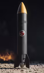 a close up of a rocket on sand