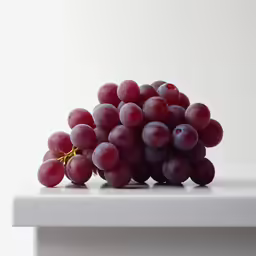 a bunch of grapes sitting on top of a counter
