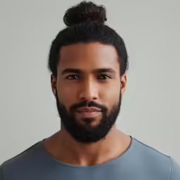 a black man with a top knot in his hair