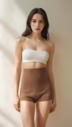 a young woman posing for the camera in a brown skirt