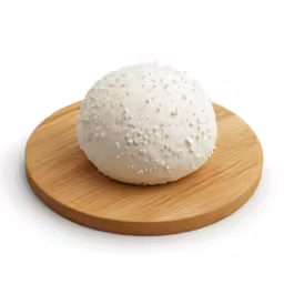 a white ball of rice sitting on a wood plate