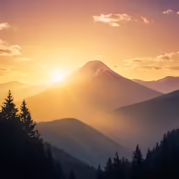 the sun sets over mountains and trees