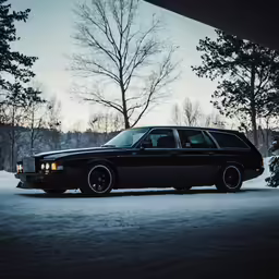 a black limo car parked on a snowy driveway