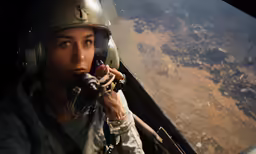 a woman wearing a helmet is holding a controller