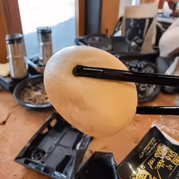an egg on top of a black plastic object