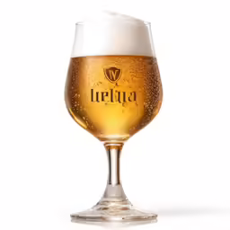 a large glass filled with beer sitting on top of a table