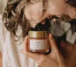 a man holding a jar of coffee looking at it