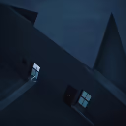 the corner of a building that is dark with windows