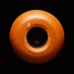 a close up image of a skateboard bearing a hole