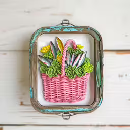 an antique metal framed photo with pink baskets of flowers,a colorfully painted wicker basket filled with plants