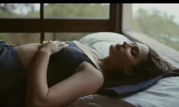 a woman laying on a bed in underwear