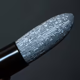 an angled camera closeup of the black handle of a makeup brush