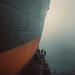 a large ship with people in front of it in the water