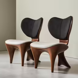 two white chairs are next to each other