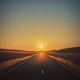 a photo of an empty road with the sun in the distance