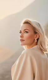 a woman with blonde hair wearing a dress and earrings